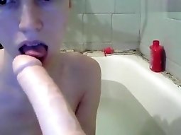 Sladkiirai sits with a toy in the bath