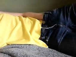 Chick lies in bed and pulls down her pants to play with her